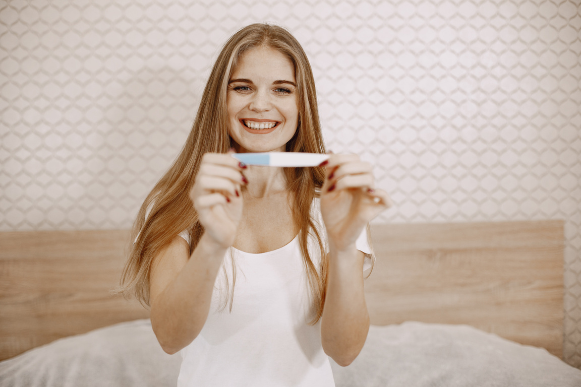 Woman Showing a Pregnancy Test